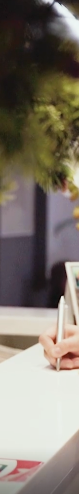 Woman filling out form at a reception desk